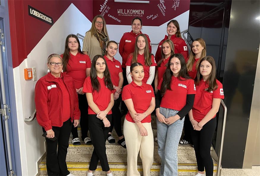 Amelie, Amina, Ayleen, Elena, Kristina, Lena, Natalie, Nikol, Sophie und Vanessa mit Rot Kreuz-Vizepräsidentin Angela Pekovics, Lesepaten-Koordinatorin Karola Hoffmann, Natalie Herold und Professorin Ramona Hedl.