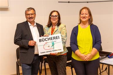 Bürgermeister Franz Pelzmann überreichte Monika Lukas und Karin Pelzmann ein neues Türschild.