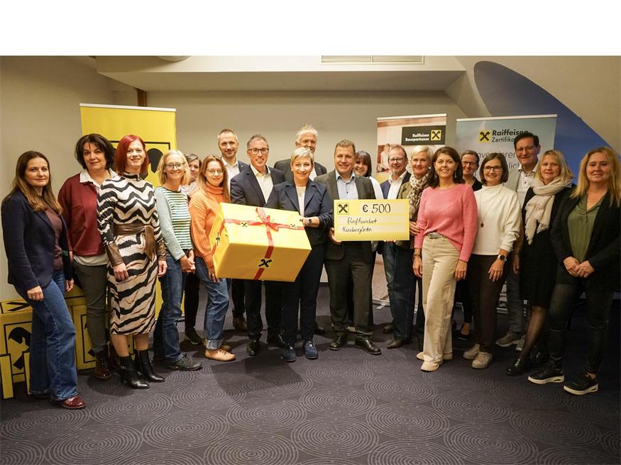 Josef Koller, Geschäftsführer der Raiffeisenbank Burgenland Mitte, mit weiteren Vertretern der Raiffeisenbank, Bürgermeistern und Kindergartenpädagoginnen bei der Scheckübergabe.