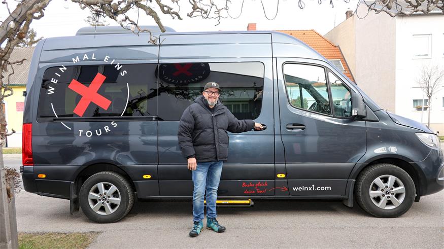 Michael Höffken vor seinem "Wein x 1-Bus", mit dem er Kunden auf Weintouren mitnimmt oder Patienten nach Bedarf zu Therapien führt. 