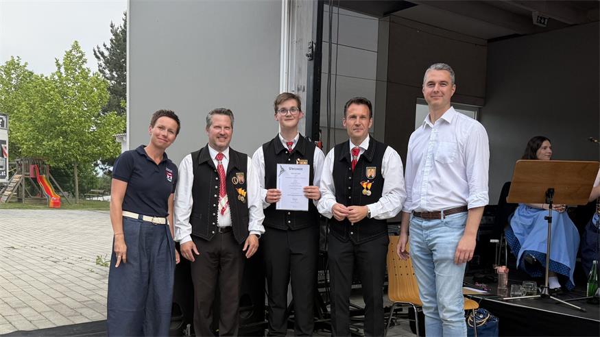 Moderatorin Petra Tritremmel, JML-Kapellmeister Marco Horvath, Obmann Wolfgang David und Bezirkskapellmeister Thomas Loier überreichten das Leistungsabzeichen in Silber an Felix Neuner.