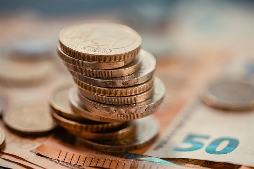 Pile of euro coins on euro notes.