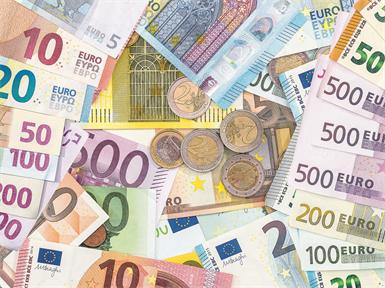 pile of different paper euro banknotes and coins cent. Saving concept